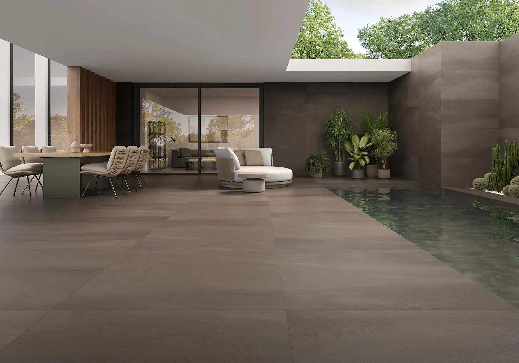Überdachte Terrasse mit dunklem, warmem Zementlook-Boden